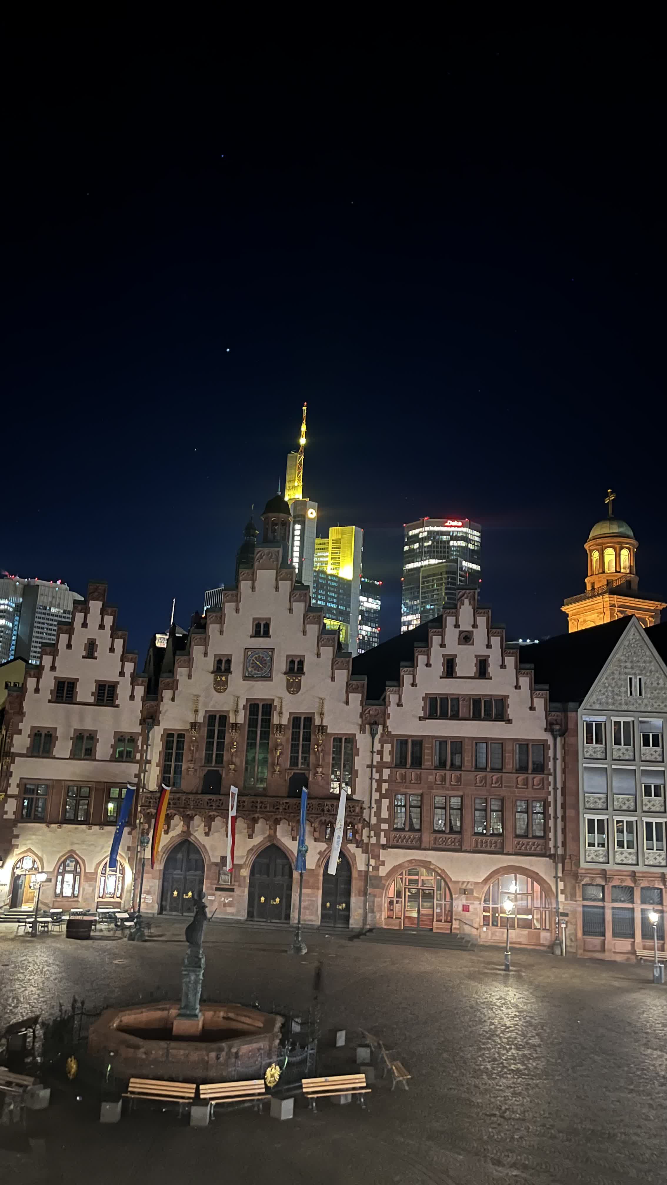 The Römerberg square at night with the lit Frankfurt banking skyline behind the old town hall